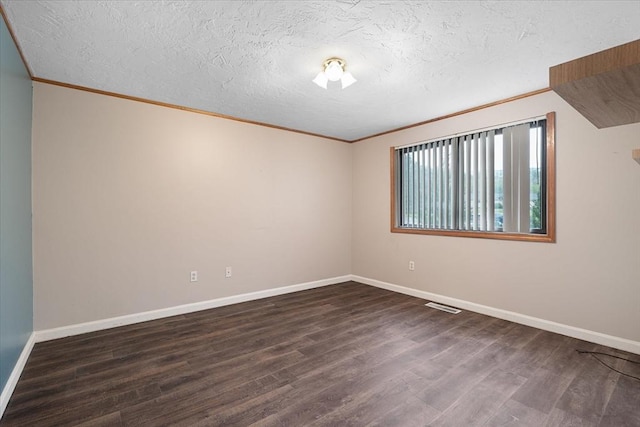 unfurnished room featuring wood finished floors, ornamental molding, baseboards, and a textured ceiling