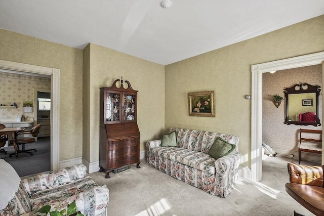 living area featuring wallpapered walls and carpet flooring