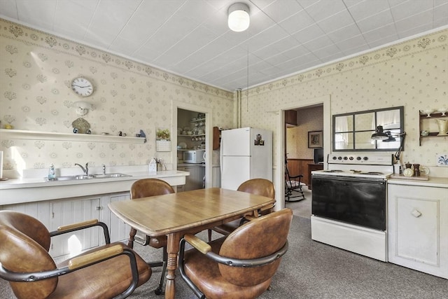 dining area featuring wallpapered walls