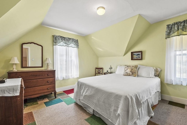 bedroom with vaulted ceiling and baseboards