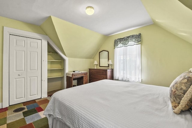 bedroom featuring vaulted ceiling and a closet
