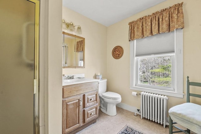 bathroom with a shower with shower door, toilet, baseboards, radiator heating unit, and vanity