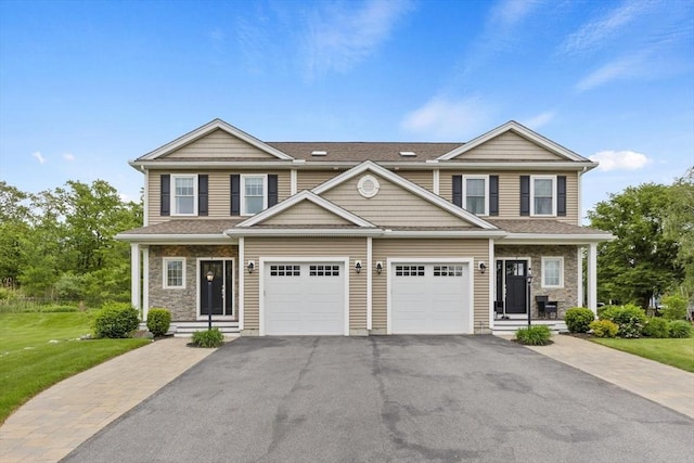 7 Garvey Rd Unit 7, Woburn, MA 01801 - view of front of home featuring driveway, stone siding, a front yard, and a shingled roof