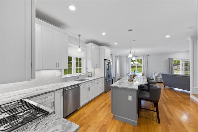 7 Garvey Rd Unit 7, Woburn, MA 01801 - kitchen featuring stainless steel appliances, white cabinetry, healthy amount of natural light, a breakfast bar, and recessed lighting