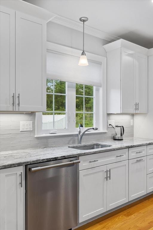 7 Garvey Rd Unit 7, Woburn, MA 01801 - kitchen featuring stainless steel dishwasher, white cabinetry, tasteful backsplash, light stone countertops, and pendant lighting