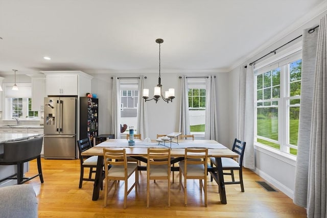 7 Garvey Rd Unit 7, Woburn, MA 01801 - dining space with a chandelier, plenty of natural light, light wood-style flooring, ornamental molding, and recessed lighting