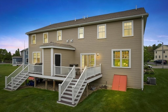 7 Garvey Rd Unit 7, Woburn, MA 01801 - back of property at dusk featuring a wooden deck, a yard, and stairs
