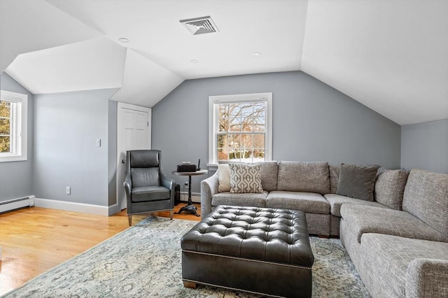 living room featuring lofted ceiling and hardwood / wood-style floors