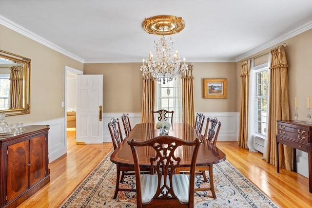 dining area featuring crown molding, a healthy amount of sunlight, and a notable chandelier