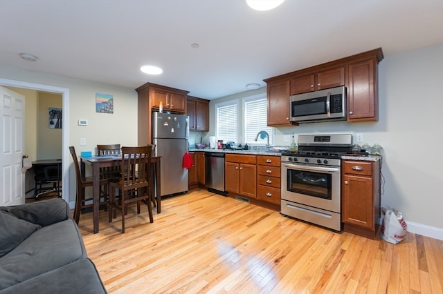 kitchen featuring light hardwood / wood-style flooring and appliances with stainless steel finishes