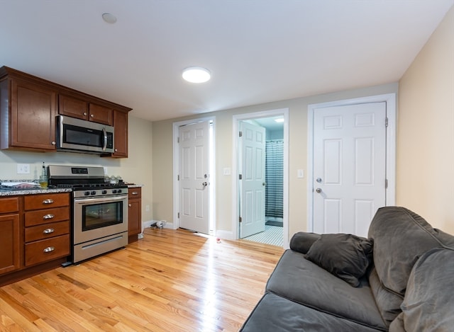 kitchen with light hardwood / wood-style floors and stainless steel appliances