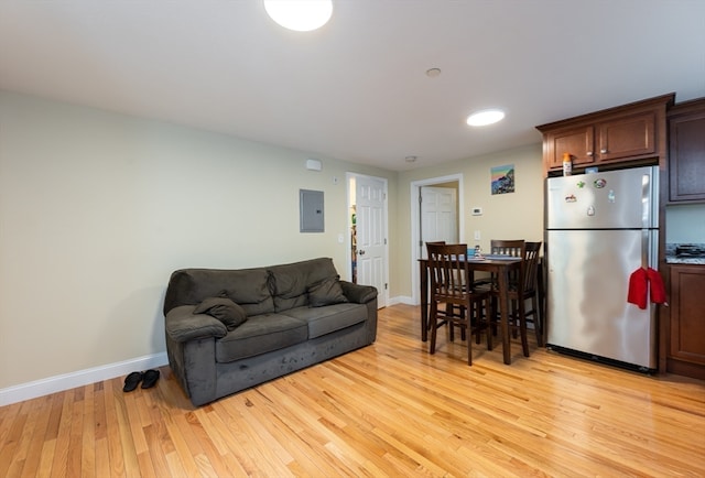 living room with light hardwood / wood-style floors and electric panel