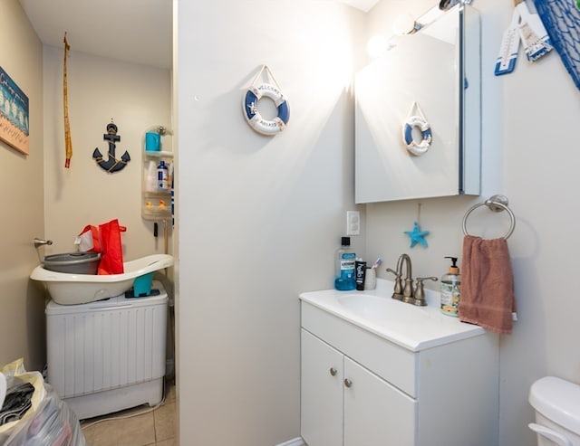 bathroom featuring vanity, toilet, and tile patterned floors