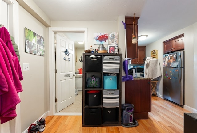 interior space featuring stainless steel refrigerator and light hardwood / wood-style floors