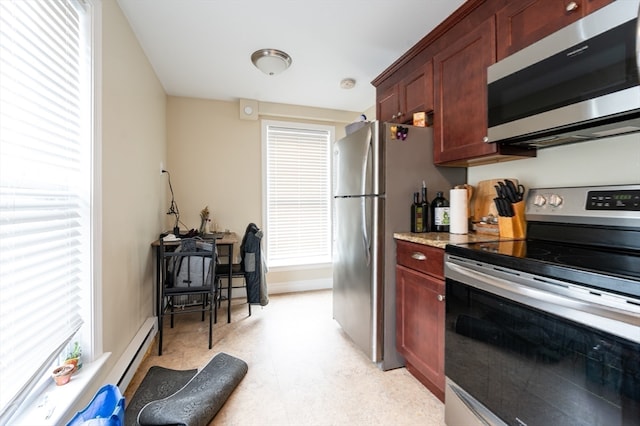 kitchen with appliances with stainless steel finishes and a baseboard radiator