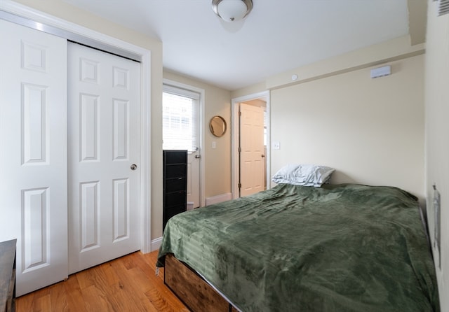 bedroom featuring light hardwood / wood-style floors and a closet