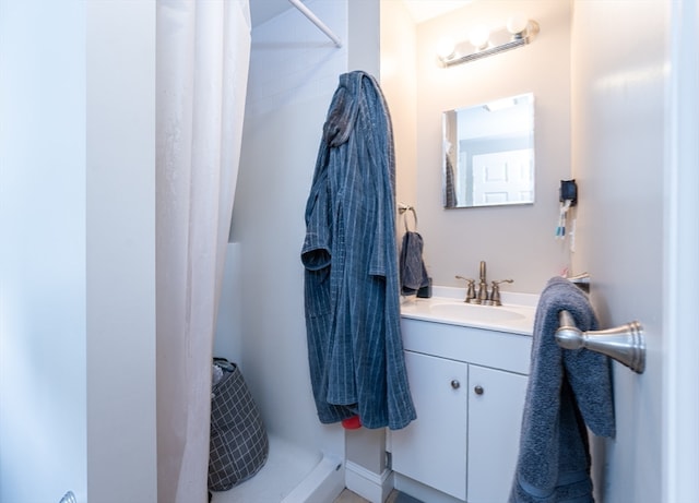 bathroom featuring vanity and curtained shower