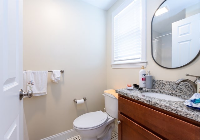 bathroom with curtained shower, vanity, toilet, and tile patterned floors