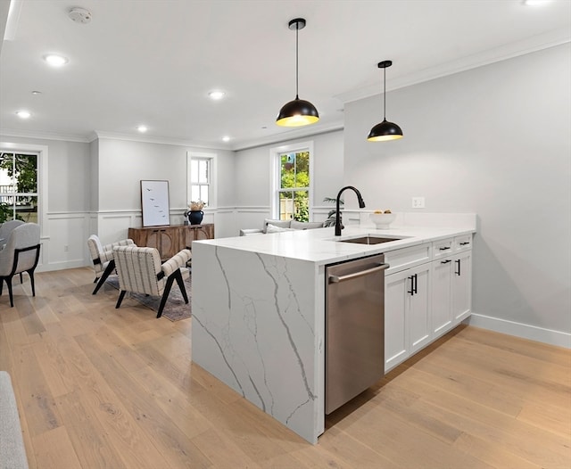 kitchen with sink, white cabinets, light hardwood / wood-style flooring, decorative light fixtures, and stainless steel dishwasher