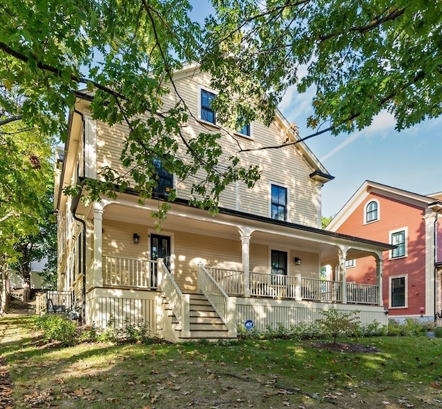 view of front of house featuring a porch and a front yard