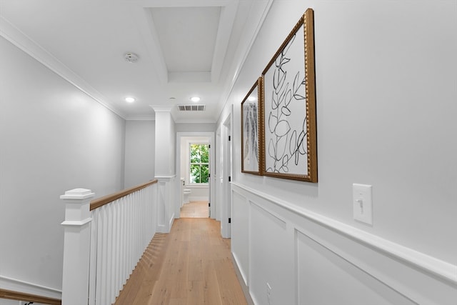 hallway featuring crown molding and light hardwood / wood-style floors