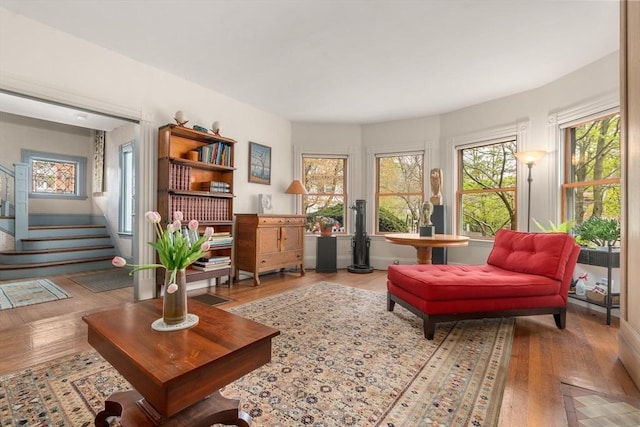 sitting room featuring wood finished floors and stairway