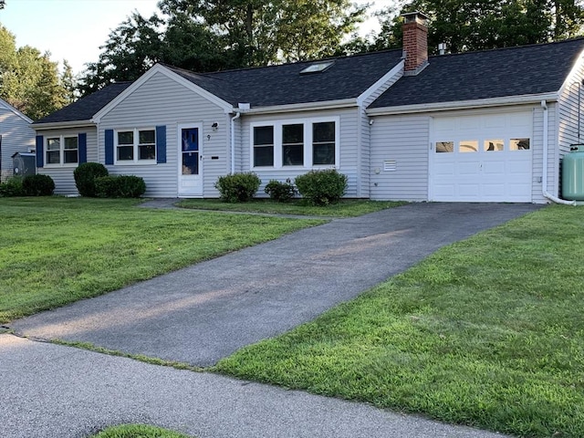 ranch-style home with a garage and a front lawn