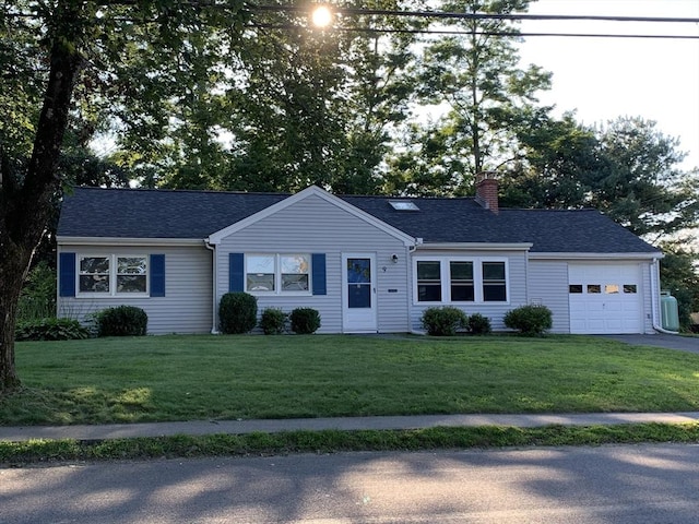 single story home featuring a garage and a front yard