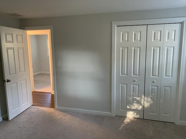 unfurnished bedroom featuring carpet and a closet