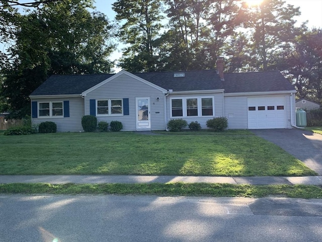 ranch-style home with a garage and a front yard