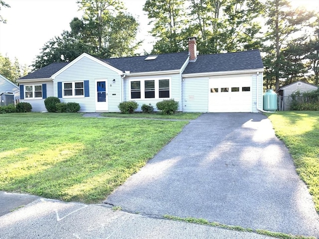 ranch-style home featuring a garage and a front yard