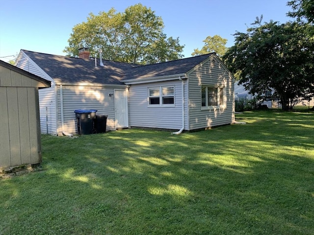 rear view of house with a lawn