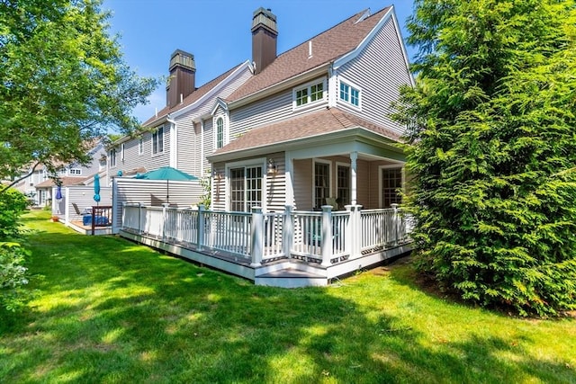 15 Hampton Ct Unit 15, Mashpee, MA 02649 - back of house featuring a chimney, a deck, a yard, and a shingled roof