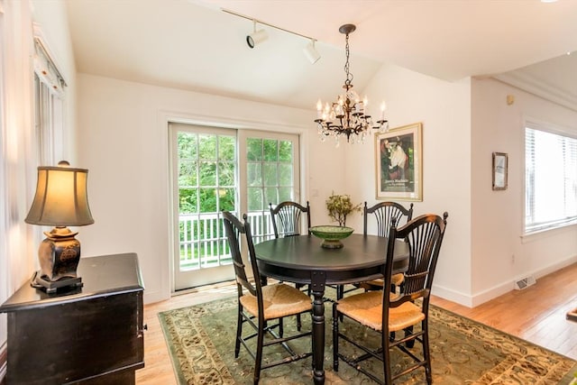 15 Hampton Ct Unit 15, Mashpee, MA 02649 - dining space with light wood-style flooring, a chandelier, rail lighting, and lofted ceiling