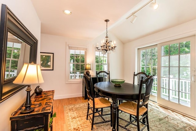 15 Hampton Ct Unit 15, Mashpee, MA 02649 - dining space with vaulted ceiling, healthy amount of natural light, a chandelier, light wood-style flooring, and rail lighting