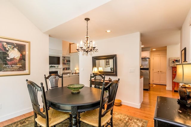 15 Hampton Ct Unit 15, Mashpee, MA 02649 - dining space featuring light wood-style flooring, a chandelier, a fireplace, and recessed lighting