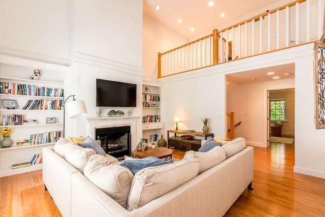 15 Hampton Ct Unit 15, Mashpee, MA 02649 - living room featuring a high ceiling, light wood-style floors, built in features, recessed lighting, and a fireplace