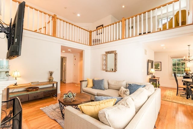 15 Hampton Ct Unit 15, Mashpee, MA 02649 - living room featuring light wood-type flooring, a towering ceiling, a chandelier, and recessed lighting