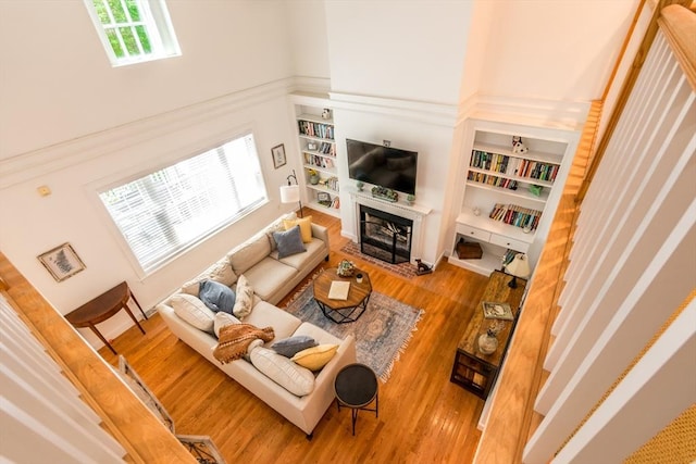 15 Hampton Ct Unit 15, Mashpee, MA 02649 - living room with a towering ceiling, wood finished floors, a fireplace, and built in shelves