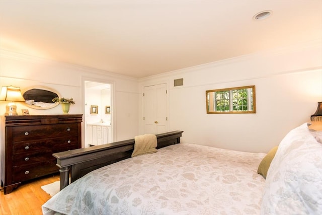 15 Hampton Ct Unit 15, Mashpee, MA 02649 - bedroom with light wood-style floors, crown molding, and ensuite bath