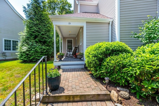 15 Hampton Ct Unit 15, Mashpee, MA 02649 - property entrance with a lawn and roof with shingles