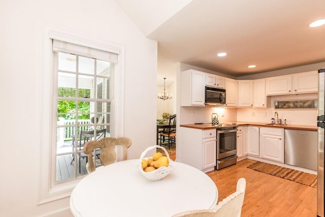 15 Hampton Ct Unit 15, Mashpee, MA 02649 - kitchen featuring stainless steel appliances, light wood-style flooring, white cabinets, recessed lighting, and butcher block countertops