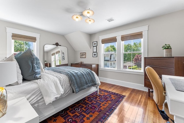 bedroom featuring baseboards and wood-type flooring