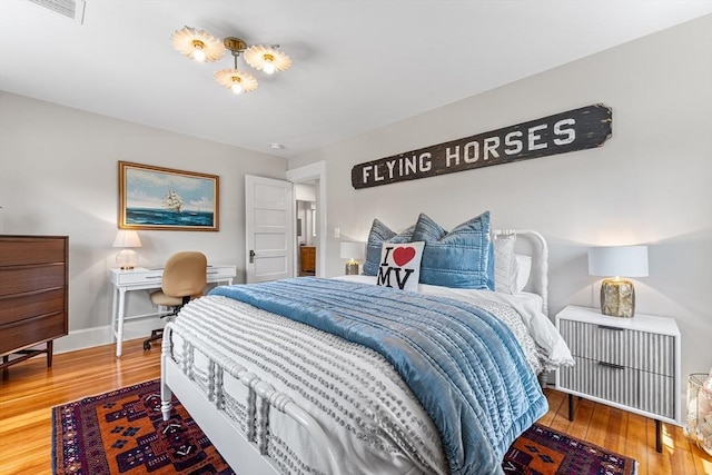 bedroom featuring baseboards and wood finished floors