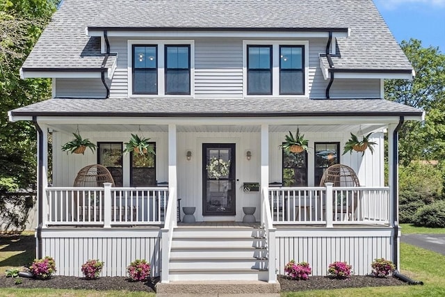 view of front of home featuring covered porch and a shingled roof