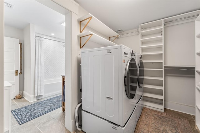 laundry room with independent washer and dryer, tile patterned flooring, baseboards, and recessed lighting