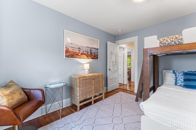 bedroom featuring wood finished floors and baseboards