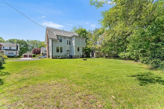rear view of property with a yard