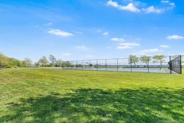 view of yard with a tennis court