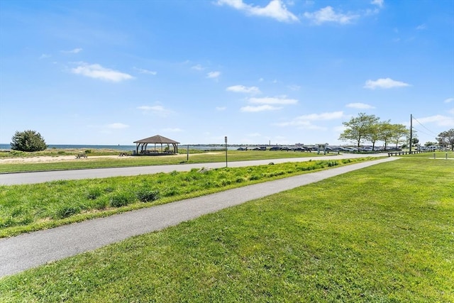 view of community featuring a gazebo, a carport, and a lawn